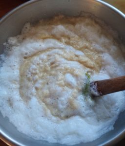 Folding the hot mixture into the creamy wheat merengue